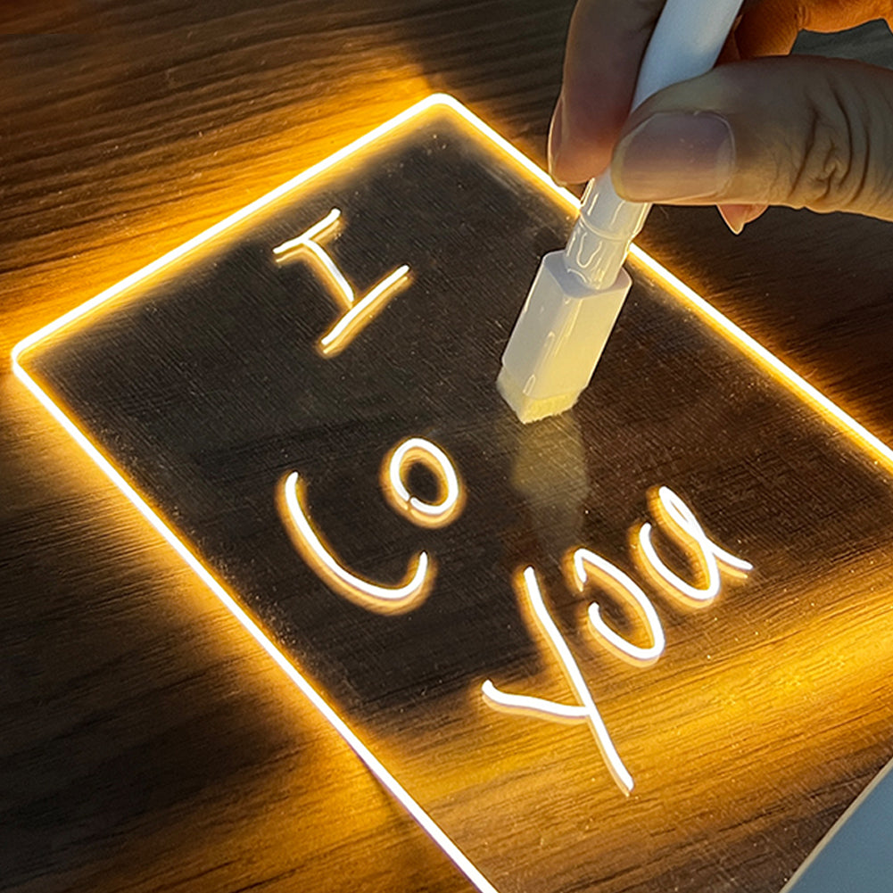 Hand writing on LED acrylic message board night light with glowing warm light