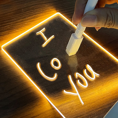 Hand writing on LED acrylic message board night light with glowing warm light